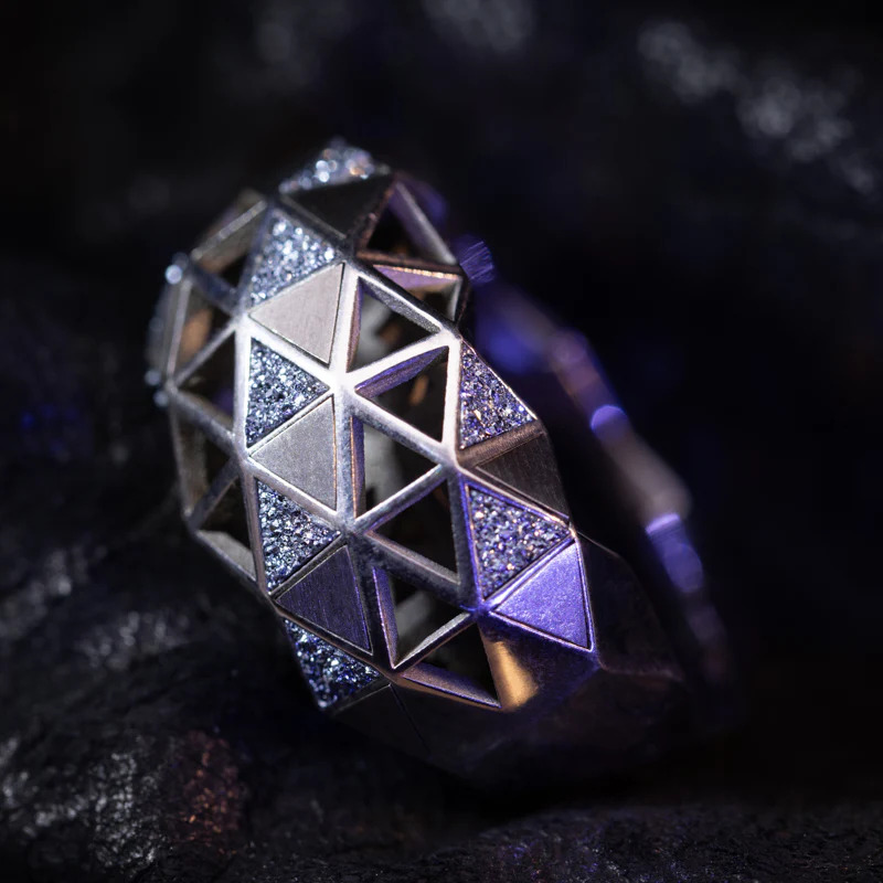 Exclusive osmium jewellery piece by designer brand showcasing rare metal inlay