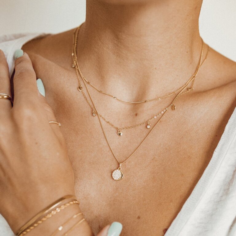 Delicate minimalist jewelry pieces with layered necklaces and rings for everyday wear